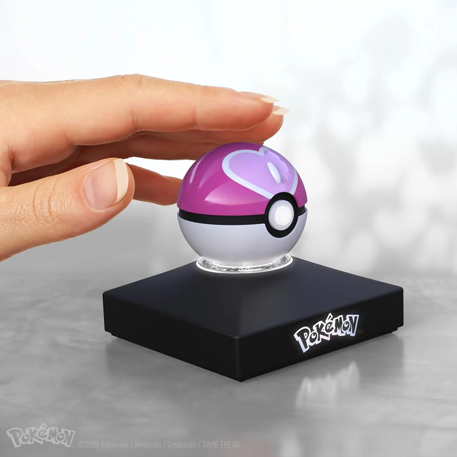 The Wand Company Pokémon Trainer Mini Poké Ball Range of Authentic Replicas - Realistic, Electronic, Die-Cast Poké Ball with Display Stand Light Features (Love Ball)